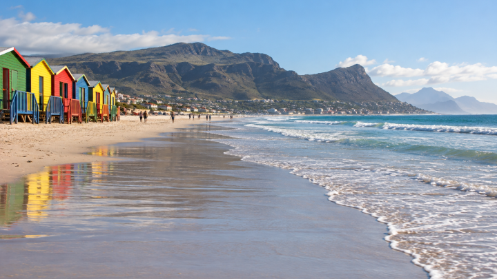 Muizenberg beach with colourful huts and False Bay mountains